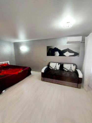 a bedroom with two beds and a red bed sidx sidx sidx sidx at Lux apartment Sadovaya street in Mykolaiv