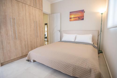 a bedroom with a large bed and a lamp at Vonitsa Luxury Apartments in Vonitsa