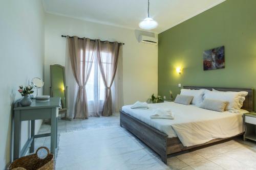 a bedroom with a large bed and a window at Villa Agathi in Roda