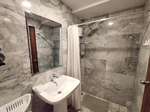 a bathroom with a sink and a shower at Heavenly place 777 on Mai Khao in Ban Mai Salae