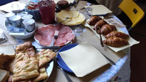 a table topped with plates of food and pastries at B&B Amarantha Gothica Genoa in Genova