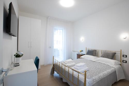 Habitación blanca con cama y TV en BB Elite Berchet, en Padua