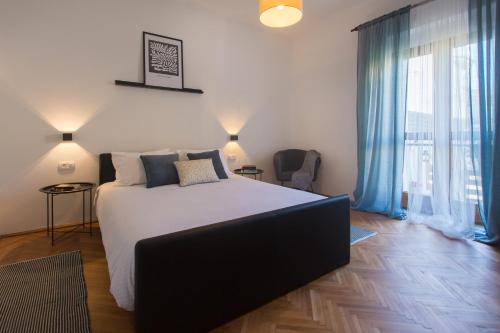 a bedroom with a bed and a large window at Holiday house VIDA in Biograd na Moru
