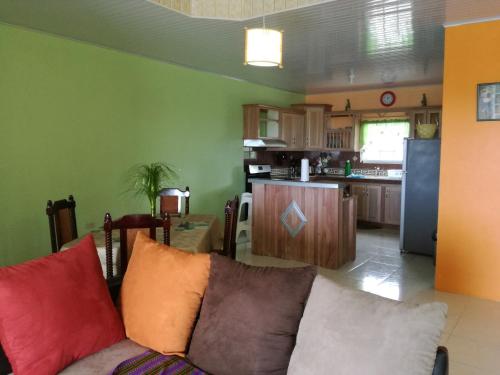 a living room with a couch and a kitchen at Pryme Paradise in Carnbee Village