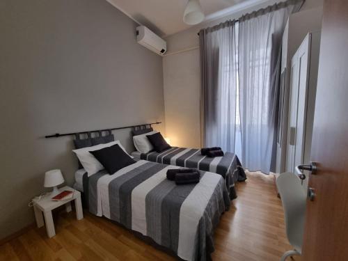 a bedroom with two beds and a window at Sa domu de su beciu in Cagliari