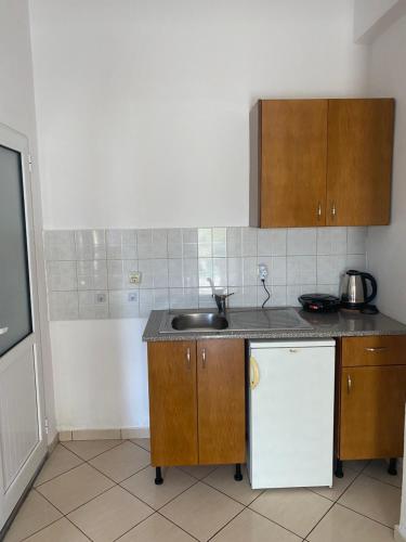 a kitchen with a sink and a counter top at Rexhos Studios in Himare