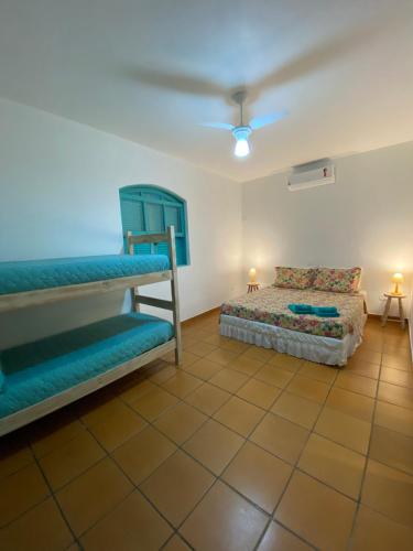 a bedroom with two bunk beds and a couch at Pousada Maria Felipa Ilhabela in Ilhabela