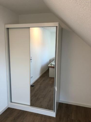 a sliding glass door in a room with a bedroom at Moderne Neubauwohnung mit Panoramablick in Neuenstadt am Kocher