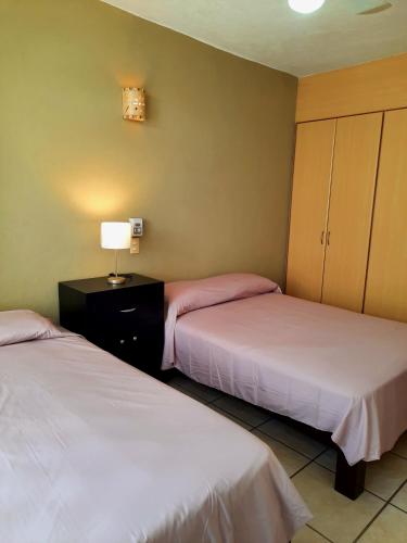 Katil atau katil-katil dalam bilik di Hacienda Real Suits Ixtapa