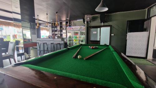 a pool table in a bar with a green pool at Golden Monkey Samui in Koh Samui 