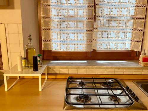 a stove top oven in a kitchen with a window at Artemisia in Pisa