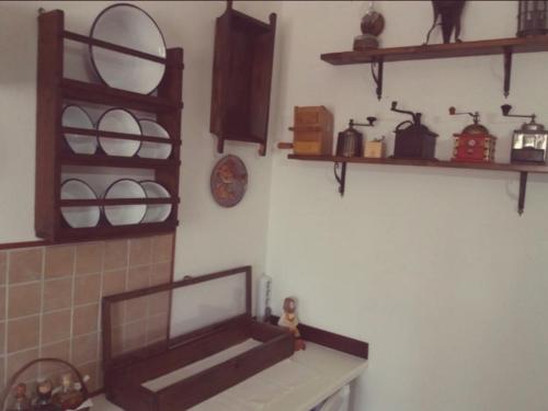 a kitchen with shelves on the wall and a counter at Belli come il Sole in Serri