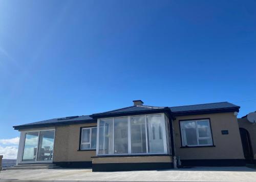 a house with a lot of windows at Cruit Island Holiday Rent in Cruit