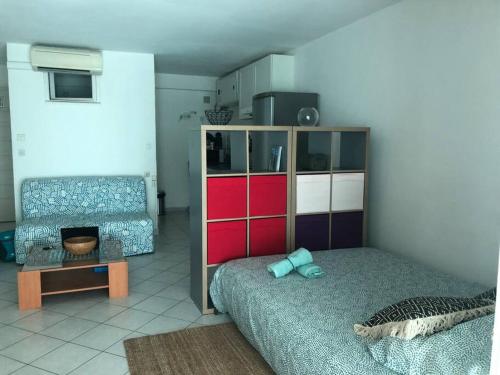 un salon avec un lit et un canapé dans l'établissement Grand Studio véranda et terrasse, à Carqueiranne