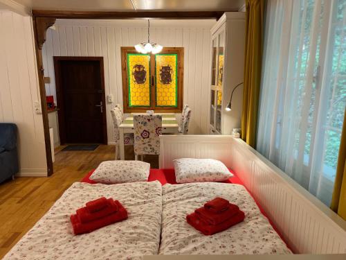 a bedroom with two beds with red pillows on them at Sommerhaus Zur Eule in Klosterneuburg