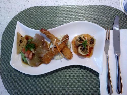 a white plate with food on a table at SenS Hotel and Spa in Ubud