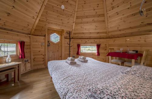 a bedroom with a bed in a log cabin at Leven View Lodges - Callart in Fort William