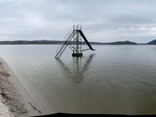 a structure in the middle of a body of water at Chatky U Davida Máchovo jezero in Staré Splavy