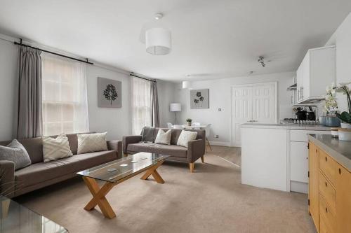 a living room with a couch and a table at No 2 The Old School House, Winchester in Winchester