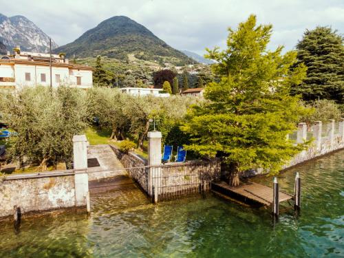 a dock in the water with mountains in the background at Lake experience! in Marone