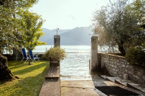 a view of a body of water with a blue chair at Lake experience! in Marone
