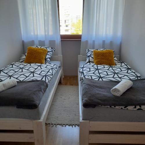 two beds in a room with a window at Mieszkanie z balkonem in Głuszyca