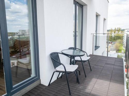 patio z 2 krzesłami i stołem na balkonie w obiekcie Semafor w Olsztynie