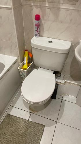 a bathroom with a white toilet and a sink at Harper Close in West Thurrock