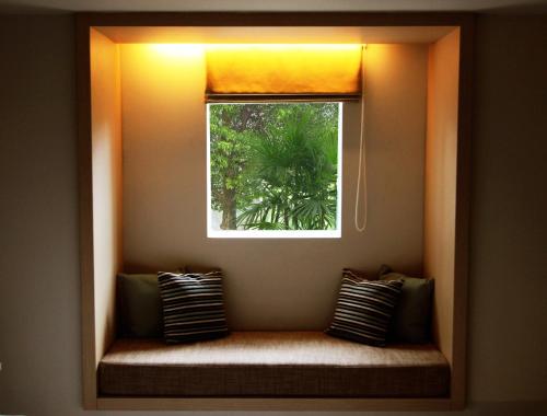 a window in a room with a bench under it at Sevn Legian in Legian