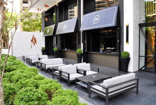 a row of chairs and tables outside of a building at G Hotel Kelawai in George Town