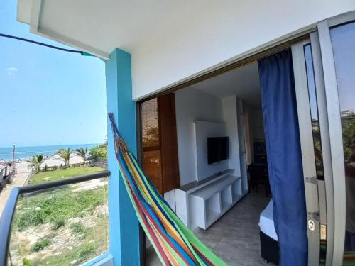 a hammock in a room with a view of the ocean at Avadia del Mar in Cartagena de Indias