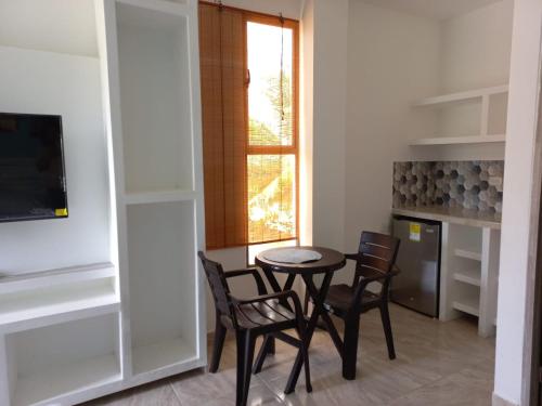 a dining room with a table and chairs and a window at Avadia del Mar in Cartagena de Indias