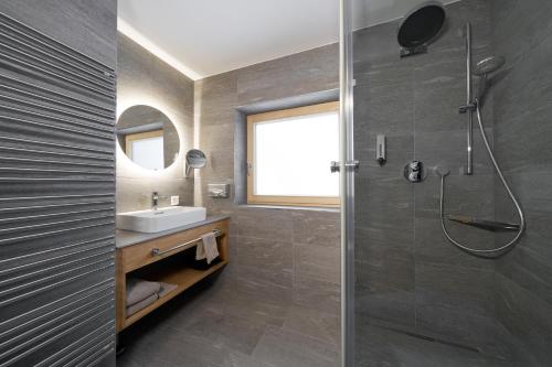 a bathroom with a shower and a sink at Aparthotel Grischuna in Samnaun