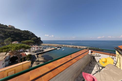 a balcony with a view of a harbor and the water at Relais del mare con terrazza fronte mare free parking in Massa Lubrense