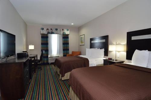 Habitación de hotel con 2 camas y TV de pantalla plana. en Quality Inn & Suites Kenedy - Karnes City, en Kenedy