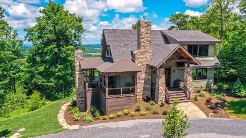 a home with a stone house with a porch at Above it All in McHenry