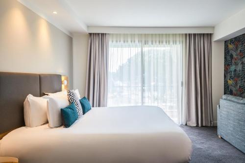 a hotel room with a large bed and a window at Holiday Inn Perpignan by IHG in Perpignan