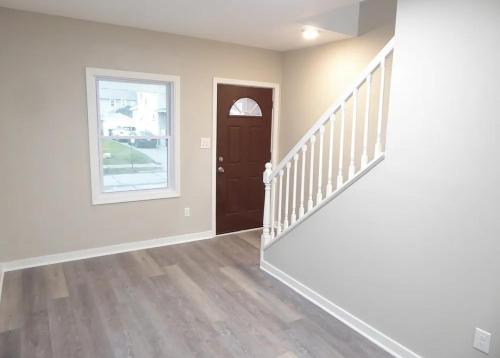 an empty room with a staircase and a door at Spacious home in Missouri City
