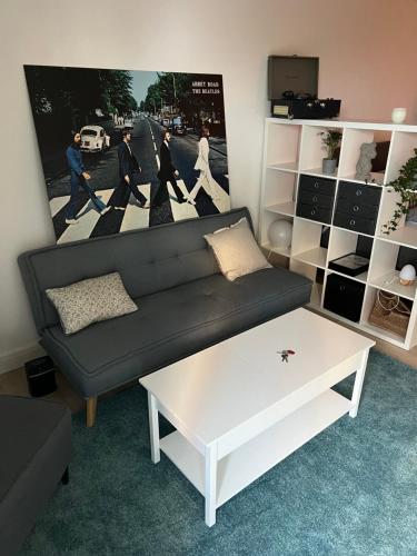 uma sala de estar com um sofá preto e uma mesa de café branca em Wunderschöne 1-Zimmer Wohnung em Wiesbaden