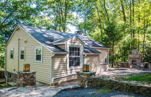 a small house with a stone wall at Ski Shore in Swanton
