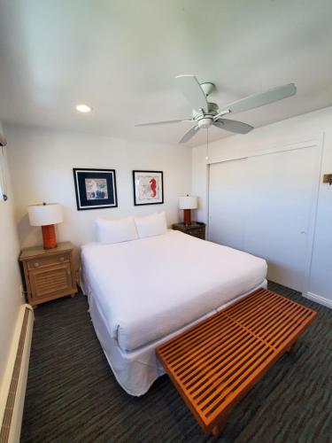 a bedroom with a large bed and a ceiling fan at Sea Horse Resort in San Clemente