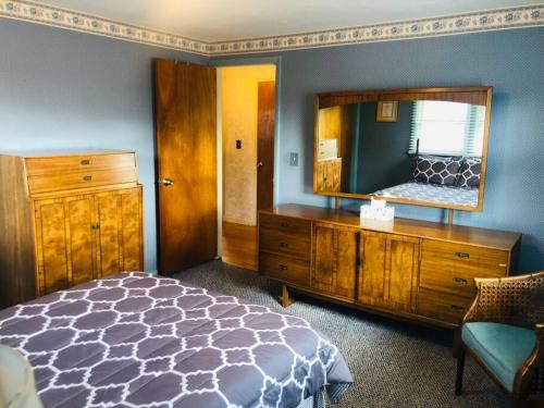 a bedroom with a mirror and a bed and a dresser at Family-Friendly Home CLOSE to SYR Univ DWNTWN & THE DOME! Location Location Location in Syracuse