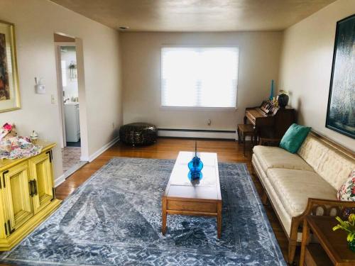 a living room with a couch and a coffee table at Family-Friendly Home CLOSE to SYR Univ DWNTWN & THE DOME! Location Location Location in Syracuse