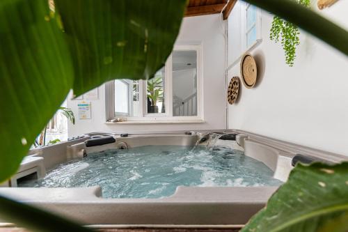 a bathroom with a tub with water in it at Anatoli Hotel in Naxos Chora