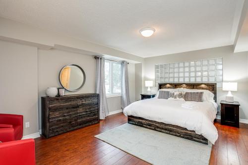 a bedroom with a large bed and a mirror at 3 Bedroom Mountain Walk Condo, Steps to Village in Blue Mountains