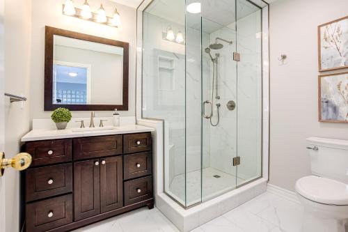 a bathroom with a glass shower and a sink at 3 Bedroom Mountain Walk Condo, Steps to Village in Blue Mountains