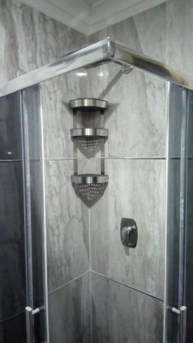 a shower stall with a glass door with a shower at Casa vacanze Maison Zio Bruno A' Scalinatella in Naples