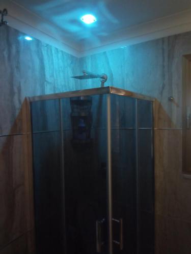 a shower with a glass door in a room at Casa vacanze Maison Zio Bruno A' Scalinatella in Naples