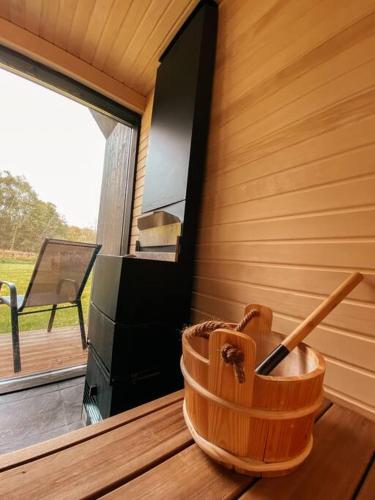 a wooden basket sitting on a table next to a television at Private Stay Zen House to unplug and recharge in Tuimõisa