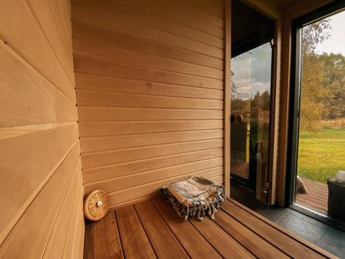a wooden room with a bench on a porch at Private Stay Zen House to unplug and recharge in Tuimõisa